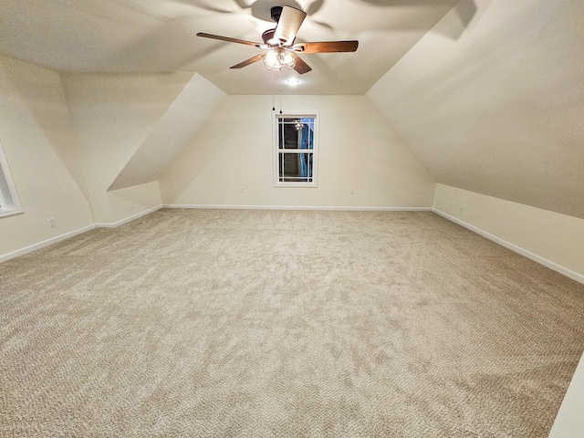 additional living space with ceiling fan, carpet flooring, and vaulted ceiling