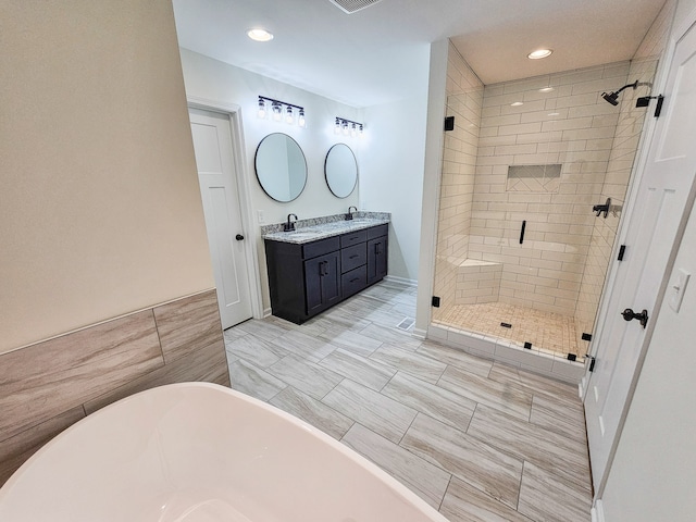 bathroom with vanity and separate shower and tub