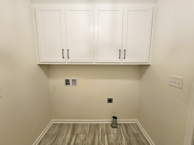 laundry area featuring hookup for a washing machine, cabinets, hookup for an electric dryer, and hardwood / wood-style floors