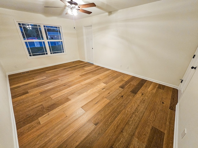 spare room with wood-type flooring and ceiling fan