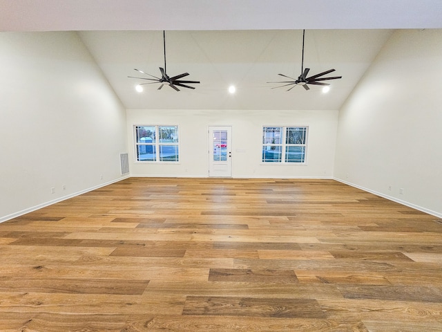 unfurnished living room with light hardwood / wood-style flooring, high vaulted ceiling, and ceiling fan