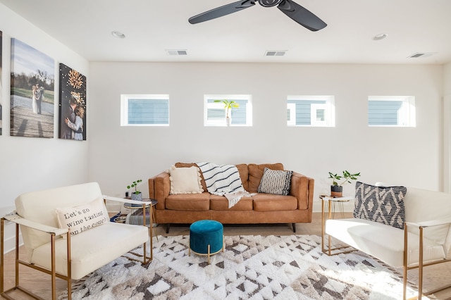 living room featuring ceiling fan and light hardwood / wood-style flooring