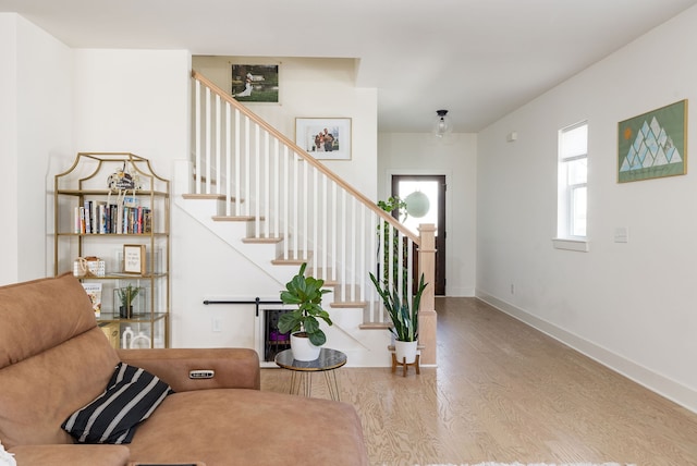 staircase featuring wood-type flooring, a barn door, and plenty of natural light