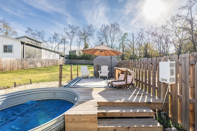 wooden deck featuring a storage shed and a yard