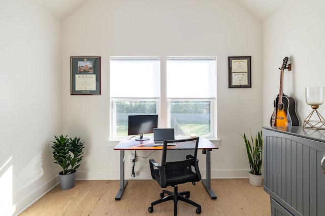 office area featuring light wood-type flooring and vaulted ceiling