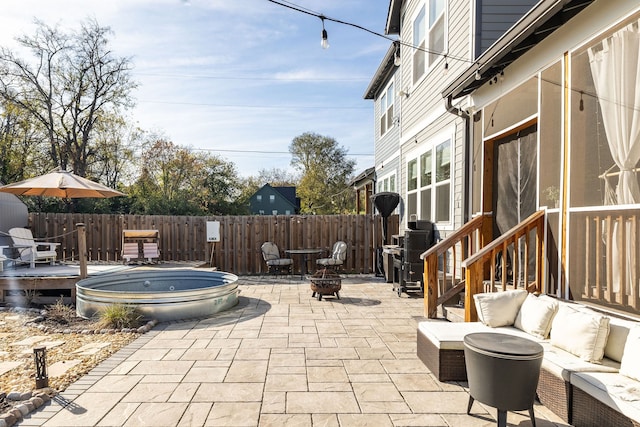 view of patio / terrace with an outdoor living space with a fire pit