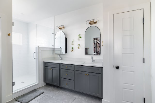 bathroom featuring tile patterned floors, vanity, and a shower with door