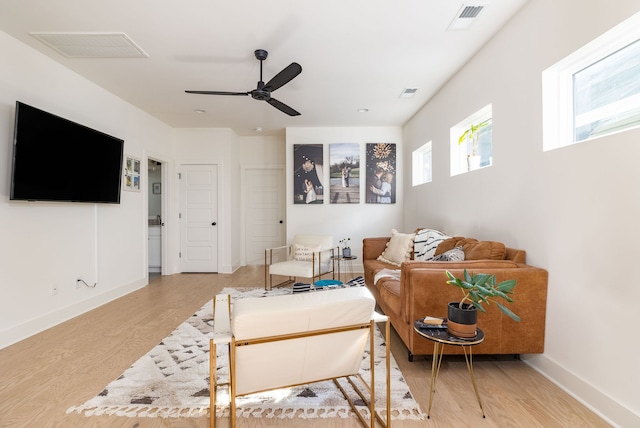 living room featuring ceiling fan and light hardwood / wood-style flooring