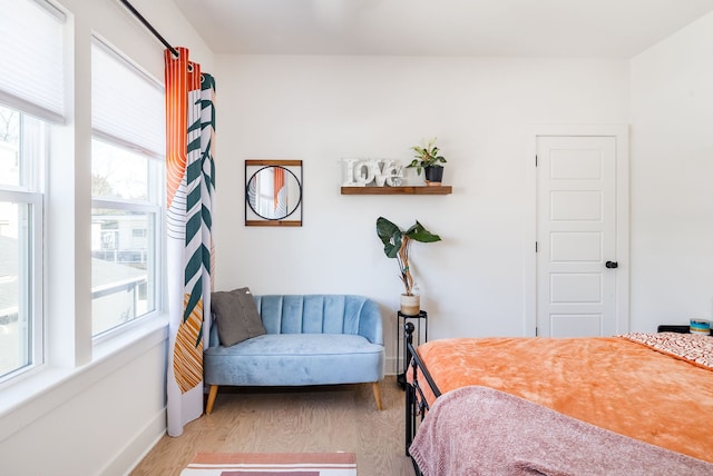 bedroom with light wood-type flooring and multiple windows