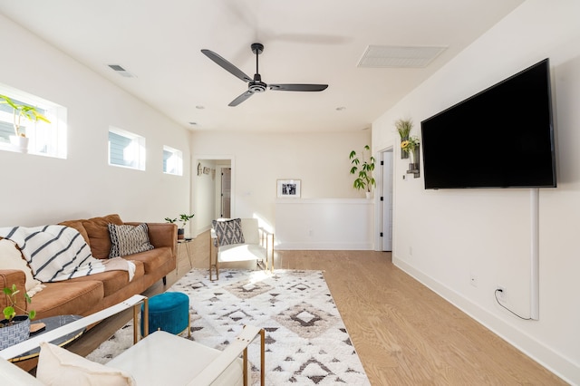 living room with ceiling fan and light wood-type flooring