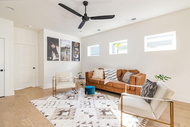 living room featuring ceiling fan and wood-type flooring