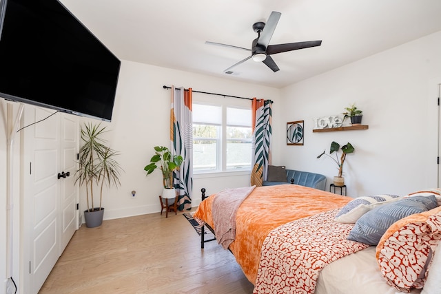 bedroom with ceiling fan and light wood-type flooring