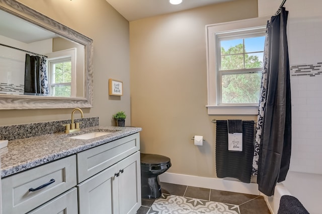 full bathroom with vanity, shower / tub combo with curtain, toilet, and tile patterned flooring