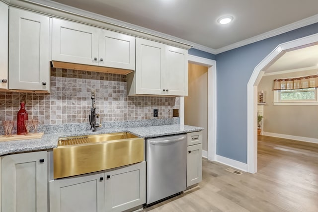 kitchen with decorative backsplash, stainless steel dishwasher, light hardwood / wood-style flooring, crown molding, and sink