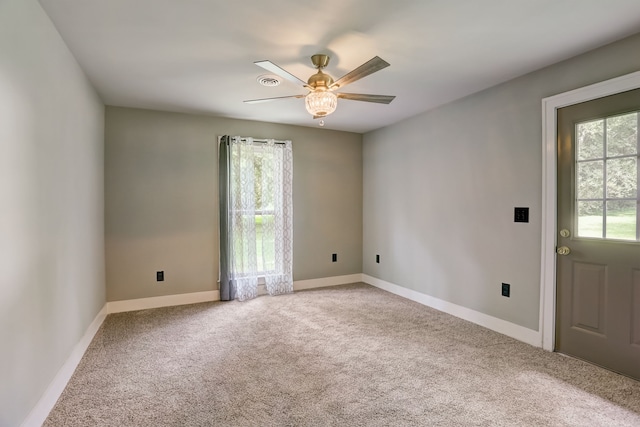 carpeted empty room featuring ceiling fan