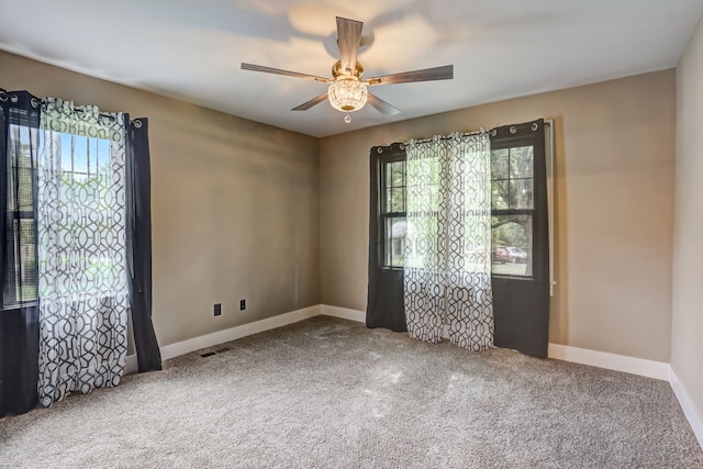 empty room with ceiling fan and carpet