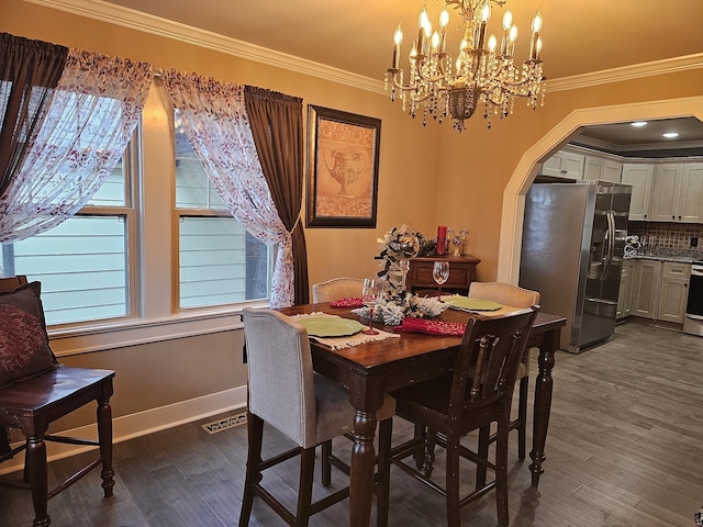 dining room with ornamental molding and dark hardwood / wood-style flooring