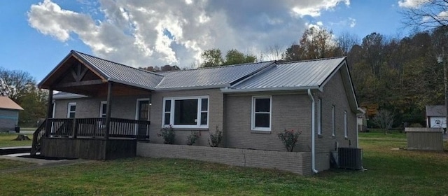 single story home featuring central AC unit and a front yard