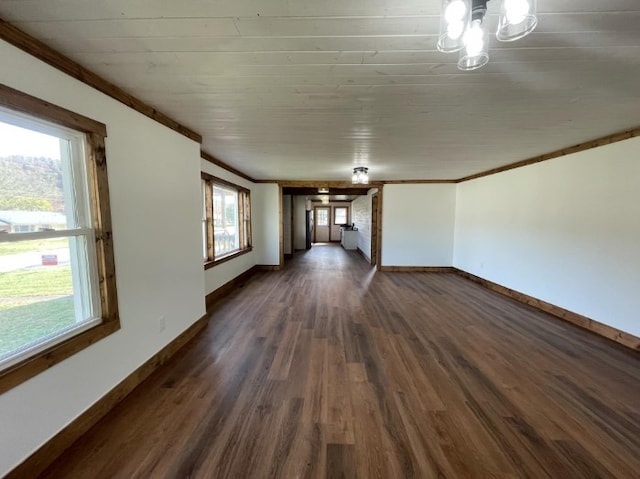 unfurnished living room with a chandelier, dark hardwood / wood-style floors, and crown molding