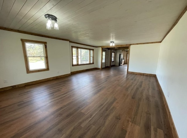 unfurnished living room featuring crown molding and dark hardwood / wood-style flooring