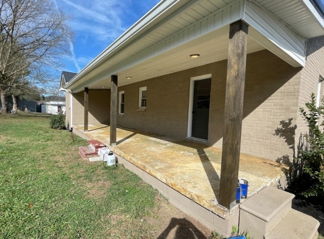 view of side of property with a lawn and a patio