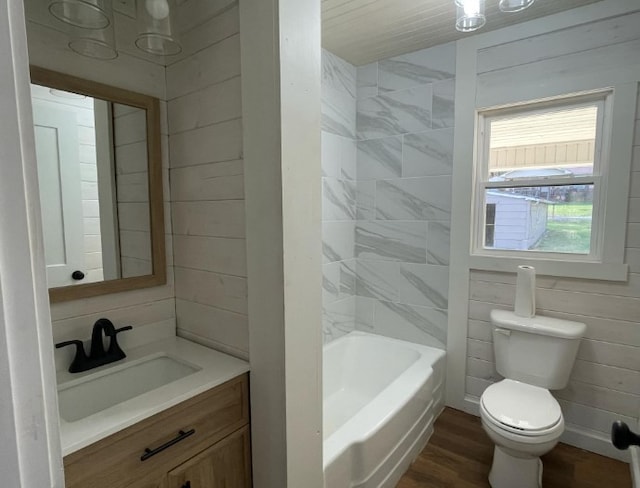 bathroom with toilet, wooden walls, vanity, and wood-type flooring