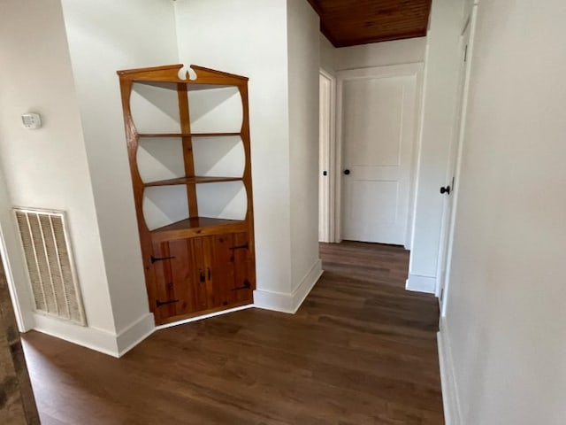 corridor featuring dark wood-type flooring and wood ceiling