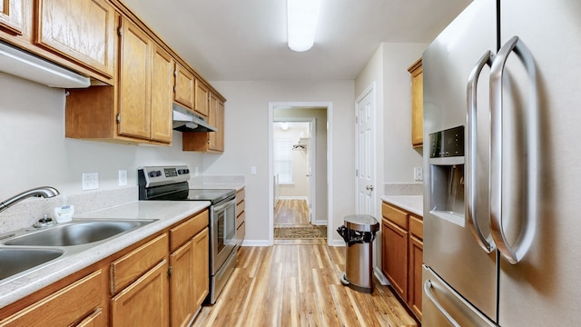 kitchen with light hardwood / wood-style flooring, stainless steel appliances, and sink