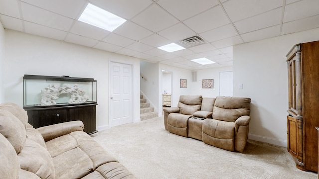 living room featuring light colored carpet and a drop ceiling