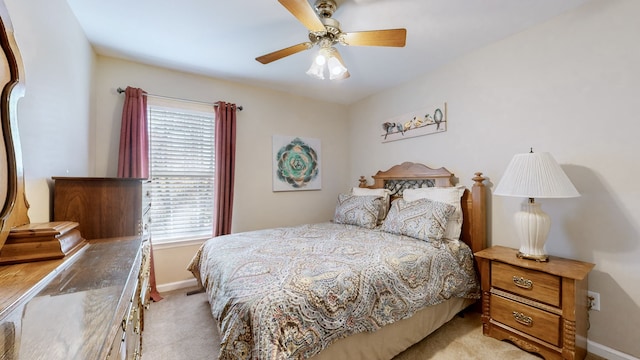 bedroom with light carpet and ceiling fan