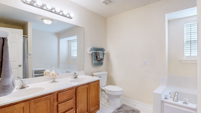 bathroom featuring toilet, vanity, a tub to relax in, and tile patterned floors