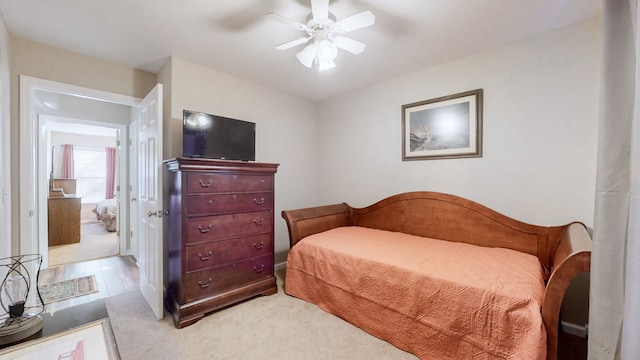 bedroom featuring ceiling fan and light carpet