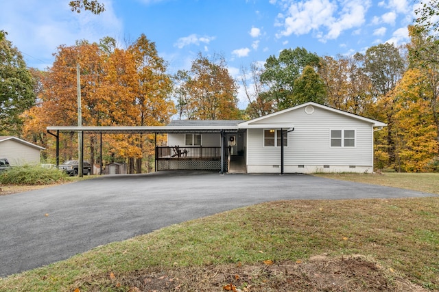 view of front facade with a front lawn and a carport