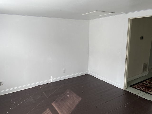 unfurnished room with dark hardwood / wood-style flooring