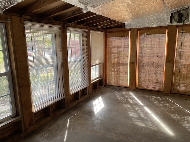 unfurnished sunroom with lofted ceiling