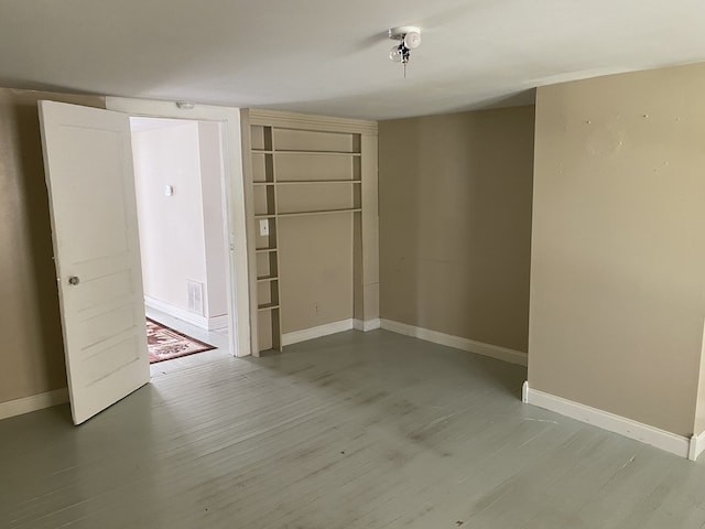 empty room with hardwood / wood-style floors