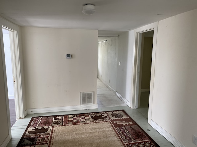 hallway with light hardwood / wood-style floors