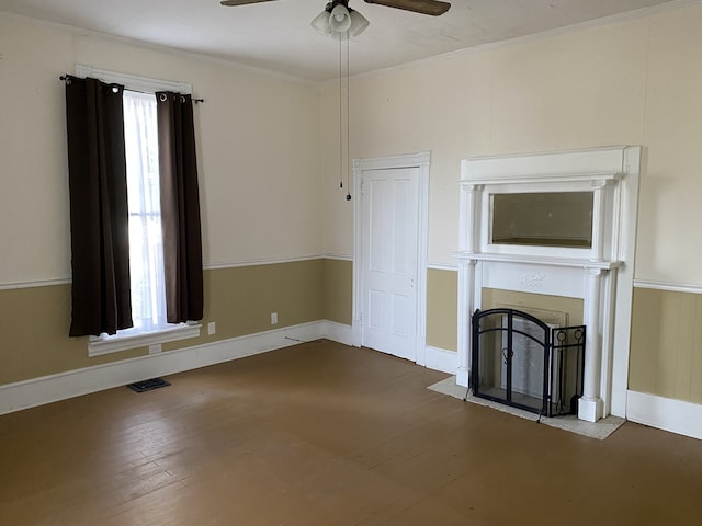 unfurnished living room featuring a fireplace, wood-type flooring, ceiling fan, and plenty of natural light