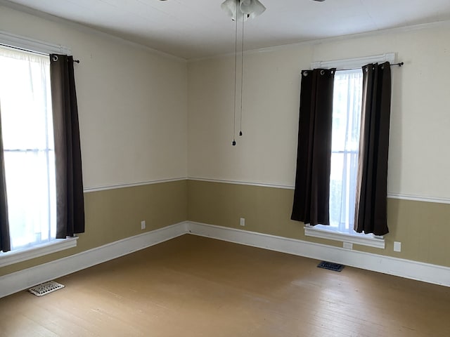 unfurnished room featuring hardwood / wood-style floors and a wealth of natural light