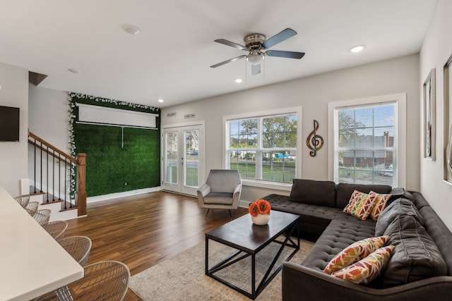 living room featuring dark wood-type flooring, plenty of natural light, and ceiling fan