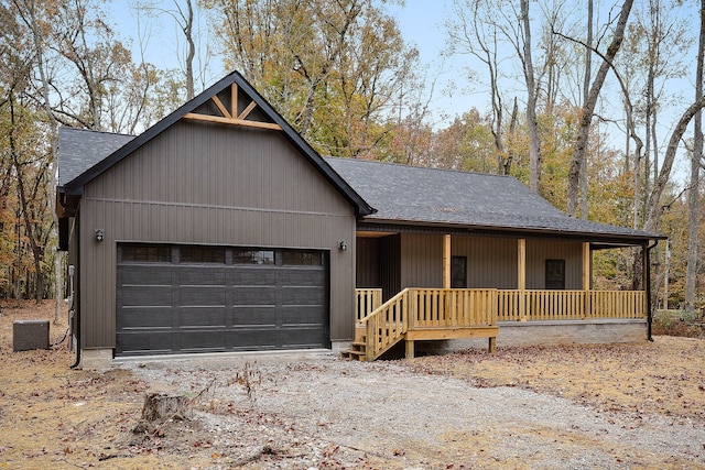 view of front of house with central AC, covered porch, and a garage