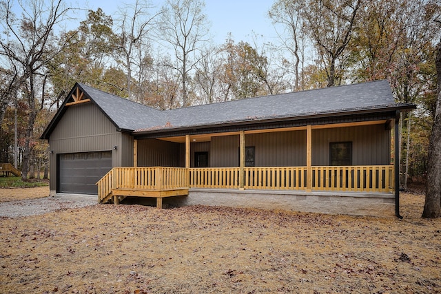 ranch-style home with covered porch and a garage