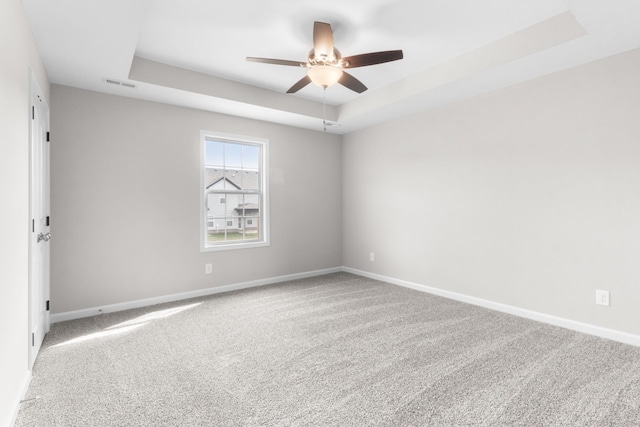646 Woodrush Dr, Clarksville, TN 37040 - carpeted spare room featuring a tray ceiling, ceiling fan, and baseboards