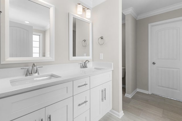646 Woodrush Dr, Clarksville, TN 37040 - full bath featuring ornamental molding, double vanity, toilet, baseboards, and wood finished floors