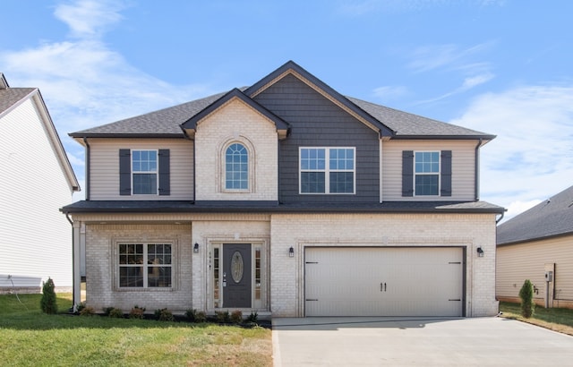 view of front of property with a front lawn and a garage