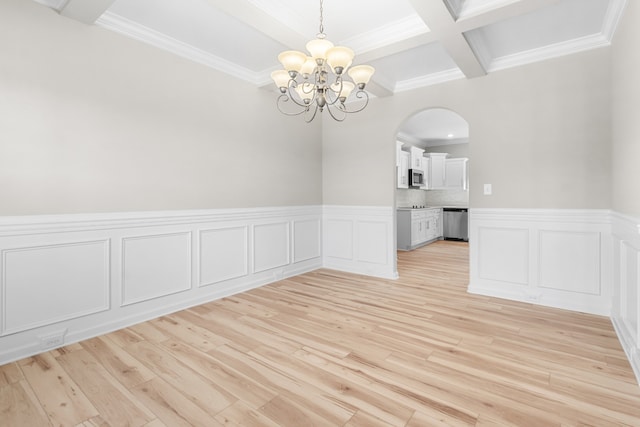 unfurnished dining area with beam ceiling, light hardwood / wood-style flooring, ornamental molding, a notable chandelier, and coffered ceiling