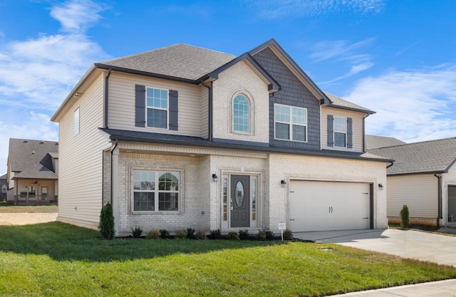 view of front of home with a front yard and a garage