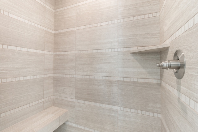 interior details with a tile shower