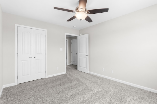 unfurnished bedroom with a closet, ceiling fan, and light carpet