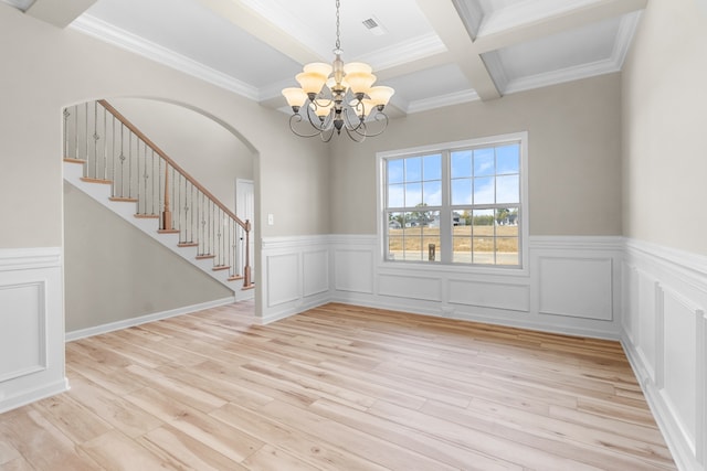 unfurnished dining area featuring beamed ceiling, crown molding, a notable chandelier, and light hardwood / wood-style floors